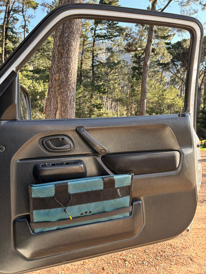 Cargo Tote in Teal folded in the side door panel of the Jimny 3