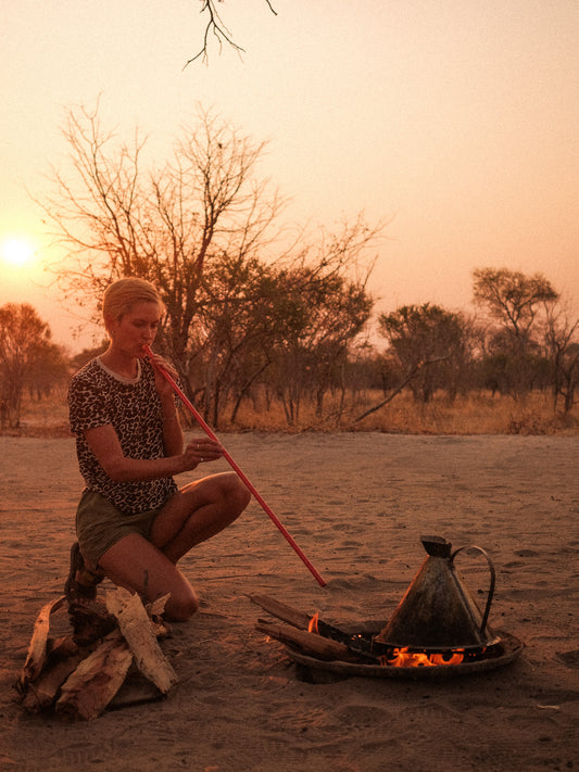 A woman showing how to use the Firestick to ignite a fire