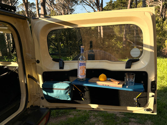 Rear Door Table in Blue with drinks set up on Jimny 4 and Utility Panel bag