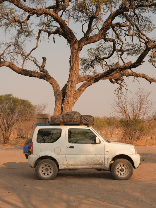 Roof Rack on a Jimny 3 Blue mounted with a roof top tent and wood box