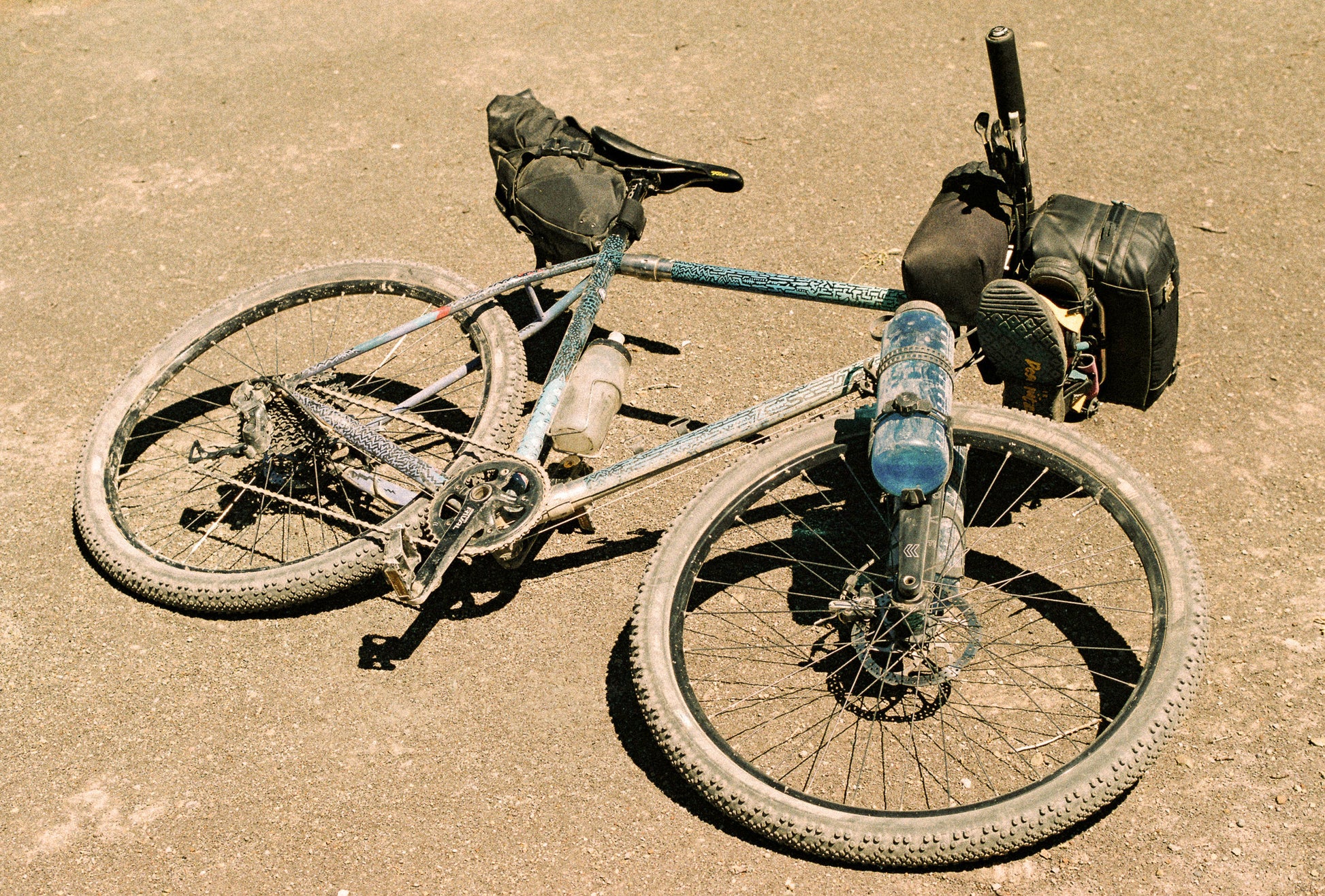 StrapOnz micro-cage cargo carrier on bicycle fork with Nalgene water bottle