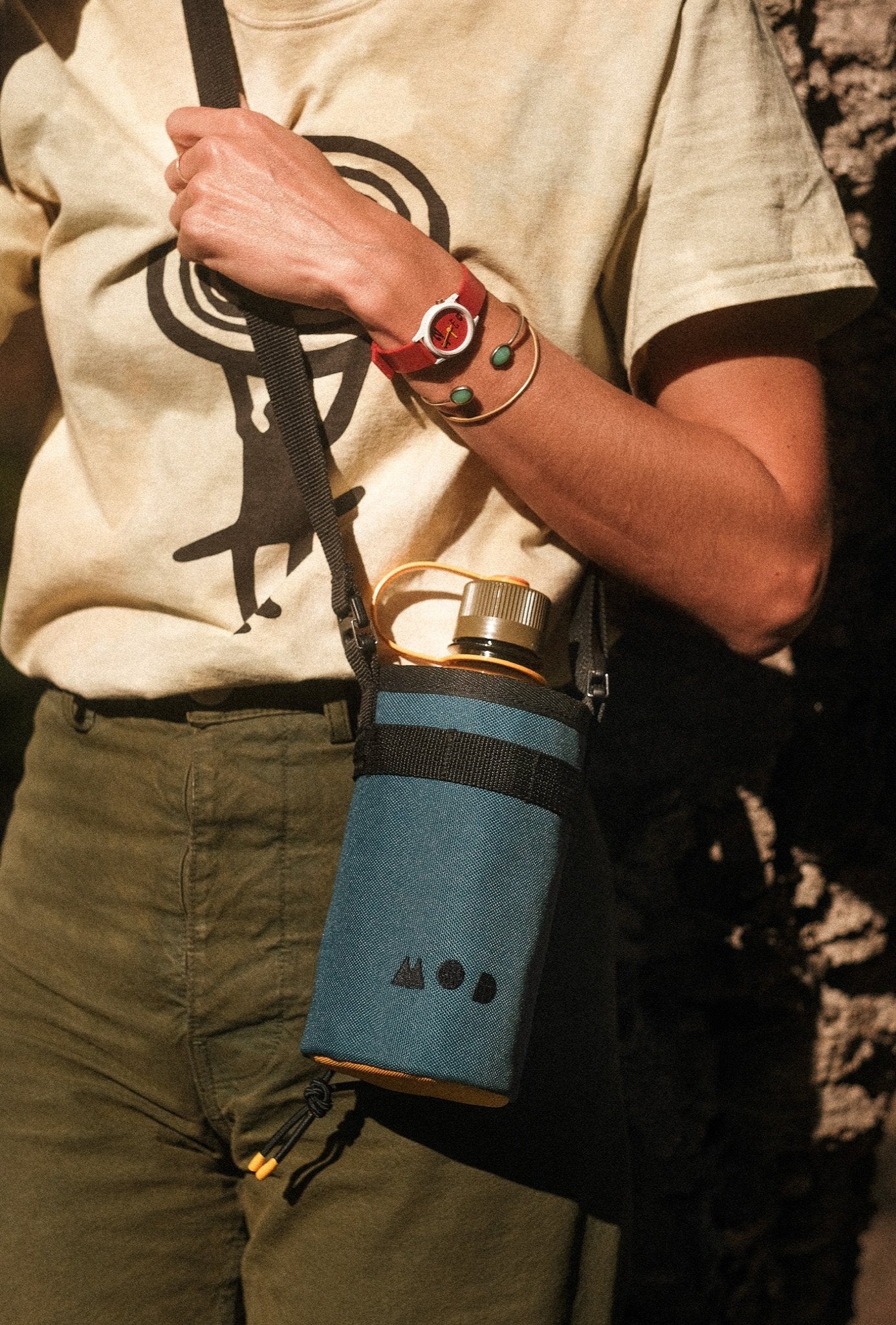 Water Bottle Pouch with Nalgene bottle and cross body strap on a woman